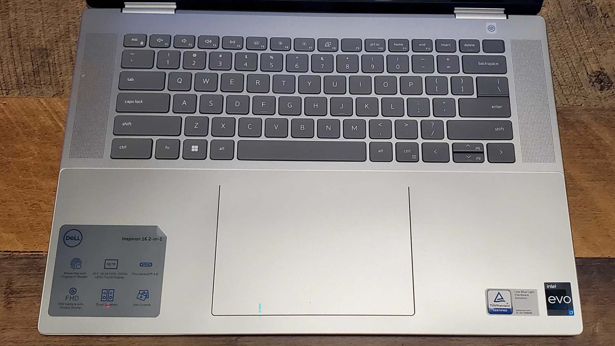 A Dell Inspiron 16 2-in-1 on a wooden desk