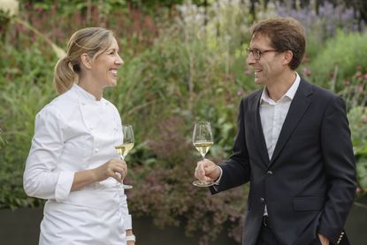 portrait of Clare Smyth, founder of Core, and Vincent Chaperon, chef de cave of Dom Pérignon, holding champagne