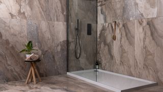 bathroom with marble effect flooring on walls and floors