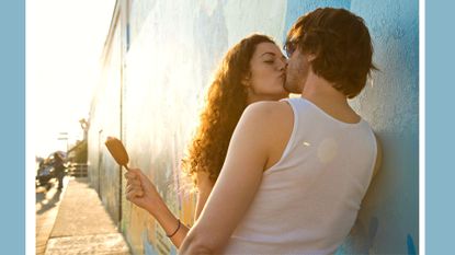 Does sunshine make you hornier? Pictured: Kissing couple leaning against wall