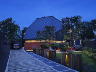 Station Lodge is an unusual London house with a huge gray pitched roof and red stairs