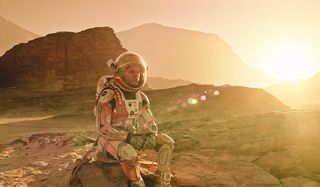 The Martian Matt Damon sitting on a martian rock