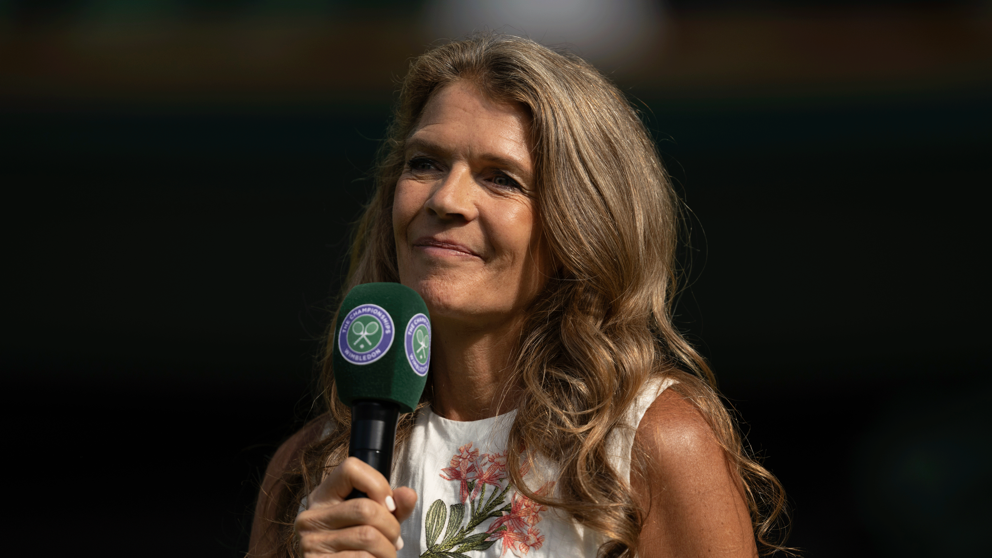 Annbel Croft holding a Wimbledon microphone