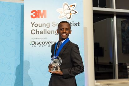 Heman Bekele holds his trophy for winning the 3M Young Scientist Challenge