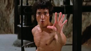 Bruce Lee swings nunchucks in Enter the Dragon