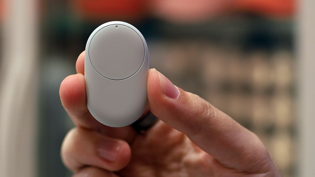 A hand holding the Google Pixel Tag
