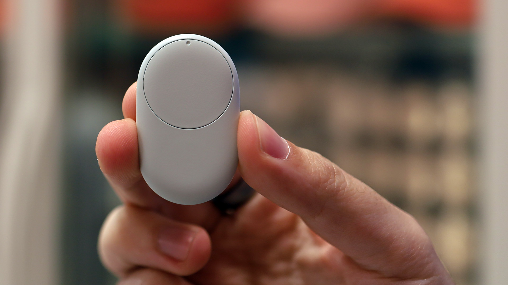 A hand holding the Google Pixel Tag
