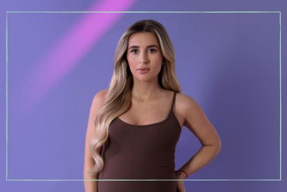 a close up of Dani Dyer posing for the camera and showing her pregnancy bump