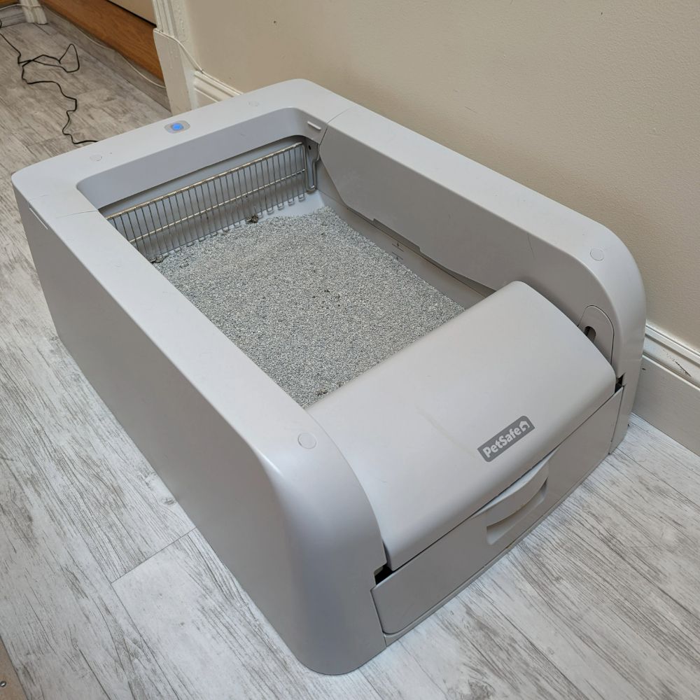 Alisa's PetSafe ScoopFree Self-Cleaning Cat Litterbox on the floor, one of the best automatic cat litter boxes