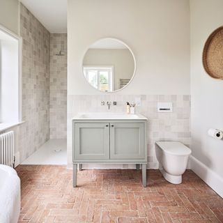 bathroom vanity unit on top of stone flooring