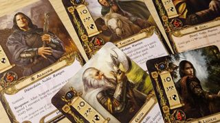 Lord of the Rings cards laid out on a wooden surface