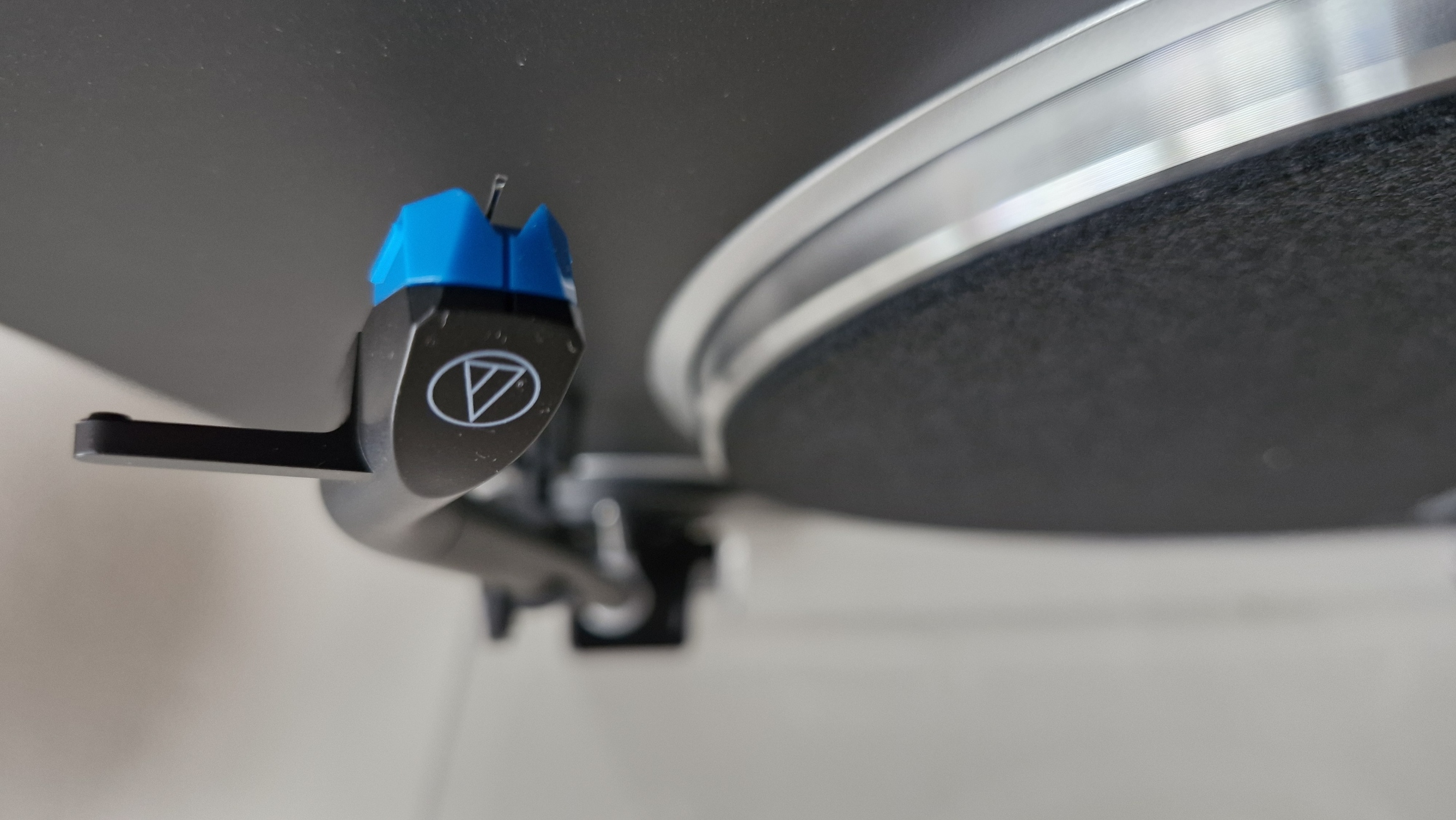 Close-up of Audio-Technica AT-LP70XBT turntable's J-shaped tonearm