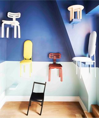 Library room with blue wall and colourfull chairs hanging on wall
