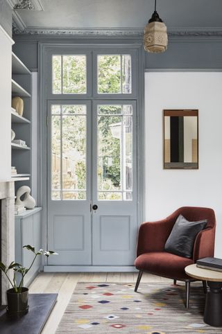 Grey door and ceeling, red velvet armchair