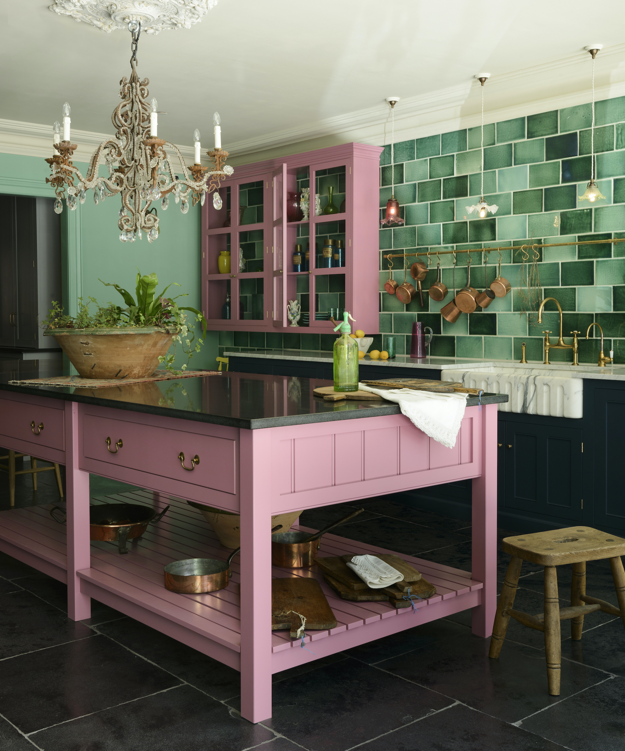 kitchen with pink island and green tiled wall