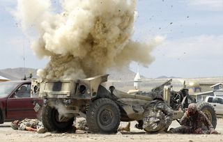 A simulated improvised explosive device detonates during a realistic training scenario at the National Training Center, Fort Irwin, Calif.