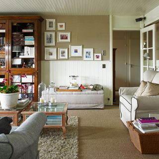 living room with carpet on floor and flower pot with frames on wall