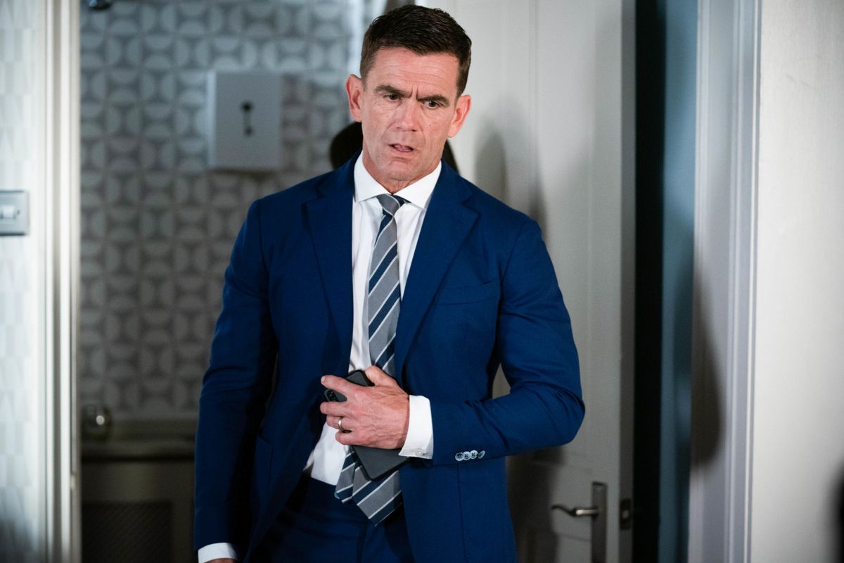 Jack Branning in a blue suit and standing in his house in EastEnders 