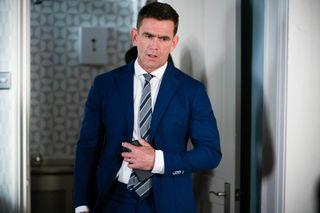 Jack Branning in a blue suit and standing in his house in EastEnders 