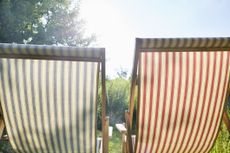 Two deck chairs in the garden retirement concept