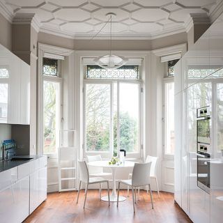 breakfast room with white door white round table and chair wooden floor