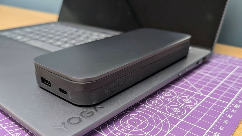 Lenovo Go USB-C laptop power bank sitting on a Yoga Slim 7i laptop to show the size