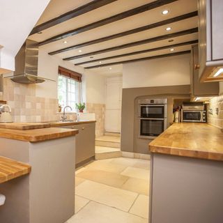 kitchen area with wooden worktop and oven
