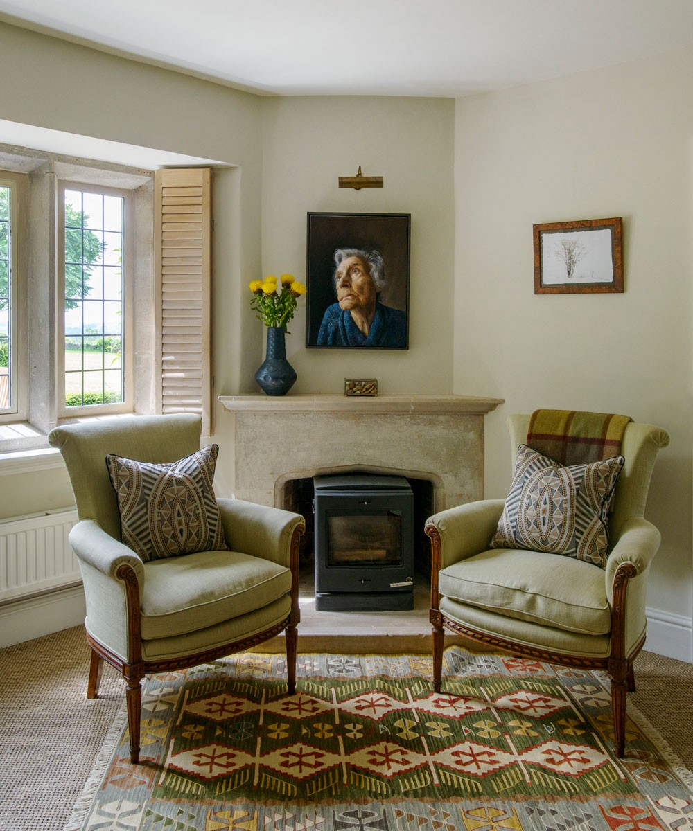 living room with carpet flooring and set of chairs