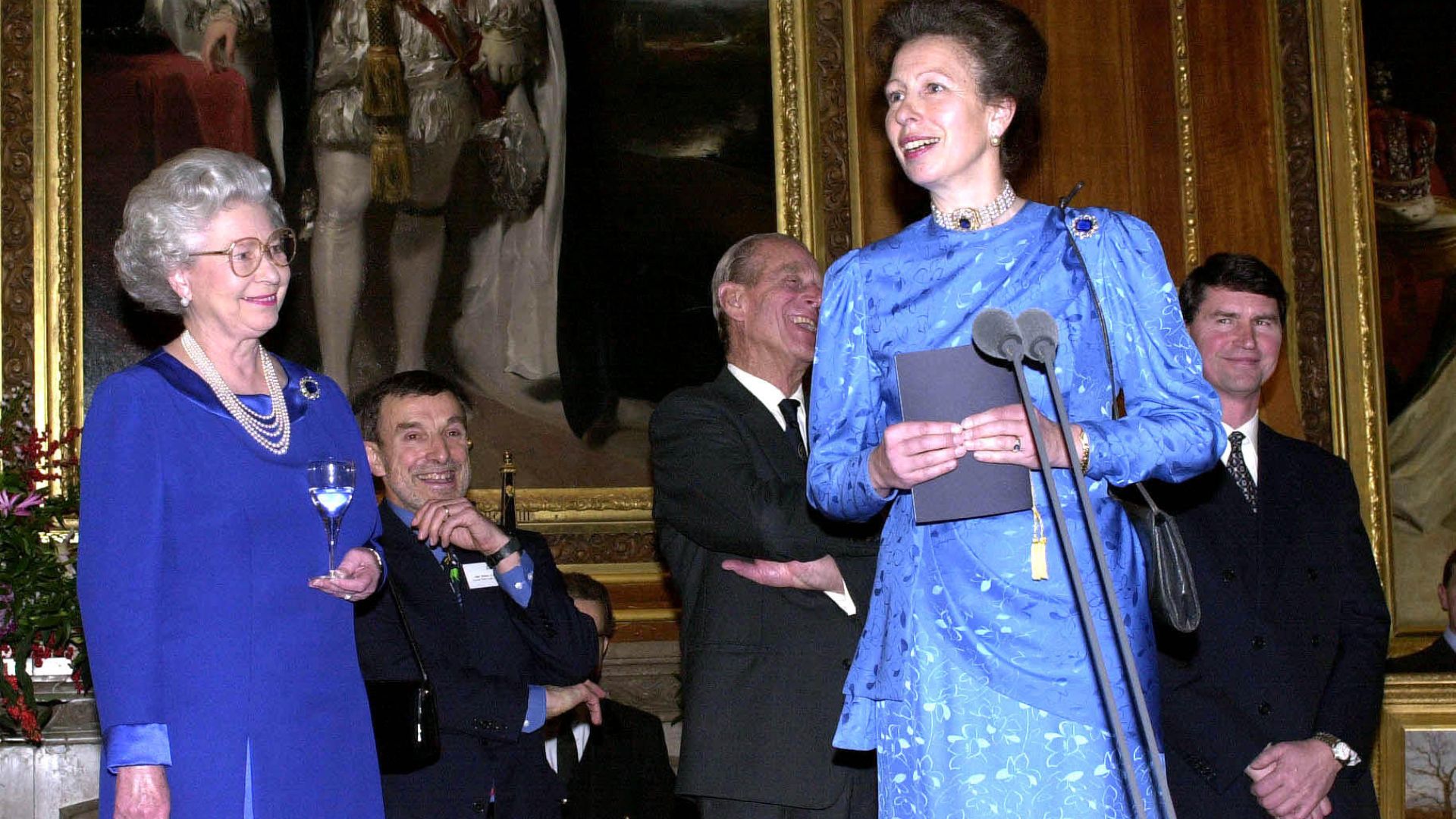 Queen Elizabeth II smiles as Princess Anne makes a speech at her 50th birthday at Windsor Castle