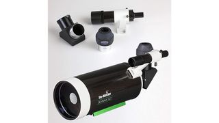 The Sky Watcher Skymax 127 and included eyepieces laid on a table