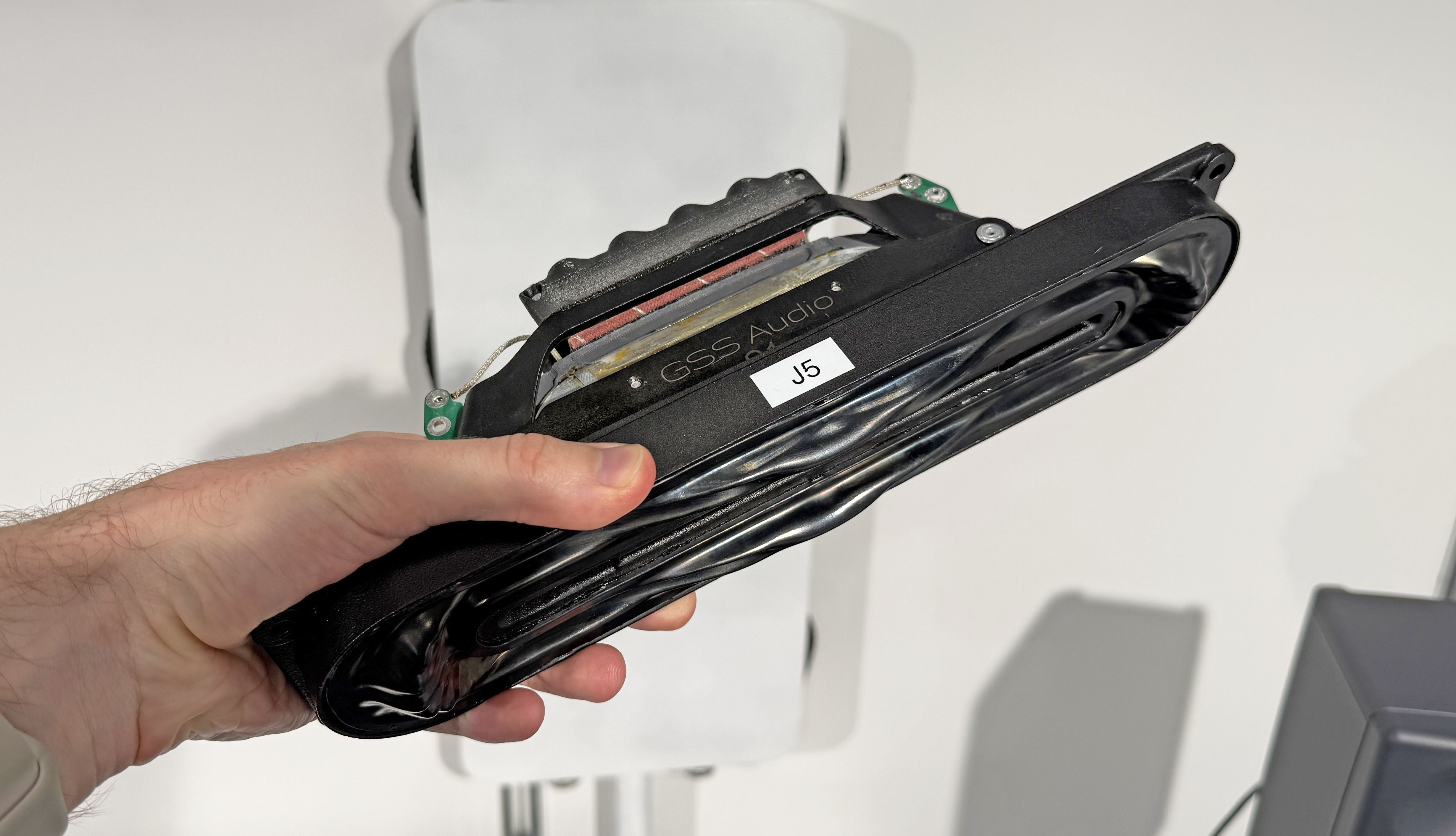 The GSS Model 1 transducer held in a man's hand, showing its small size
