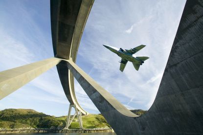 ylesku Bridge in Assynt Scotland UK, with an RAF jet flying past