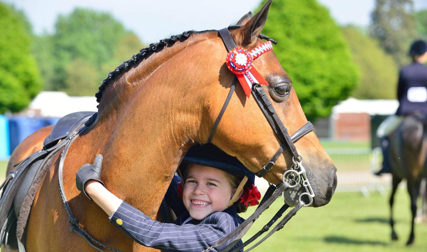 Happy child with show pony
