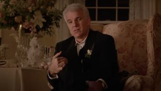 Steve sitting down in a nice suit in Father of the Bride