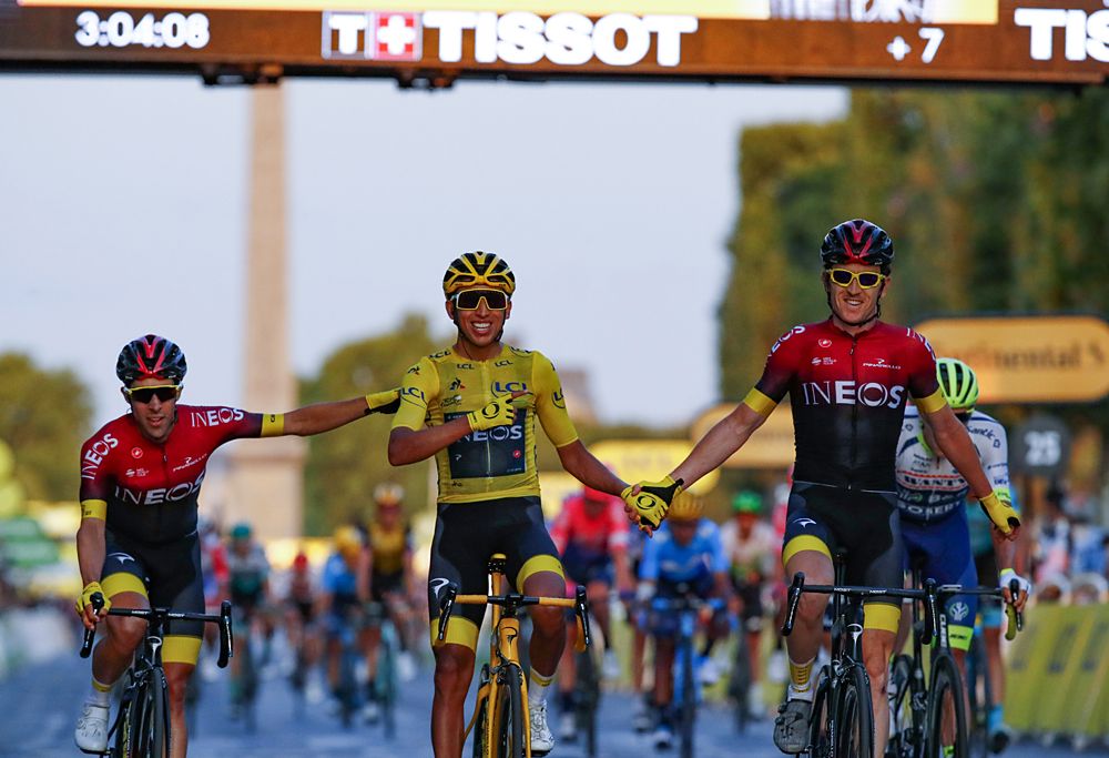 Egan Bernal (Team Ineos) celebrates with his teammates at the end of the Tour de France