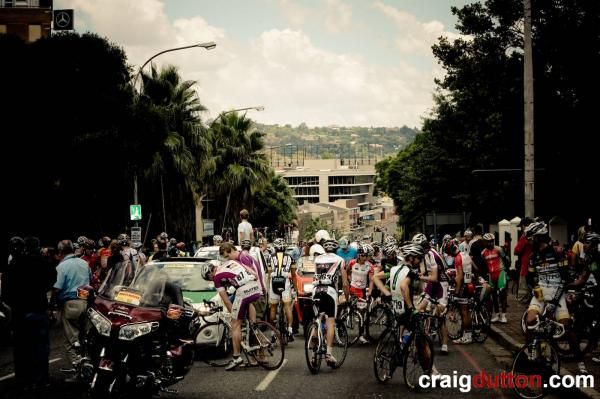 Racers are stopped while organizers try to clear the traffic.