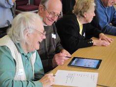Workshops participants get to grips with a tablet.