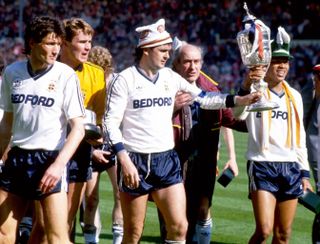 Luton Town players celebrate with the trophy after winning the 1988 League Cup final against Arsenal at Wembley