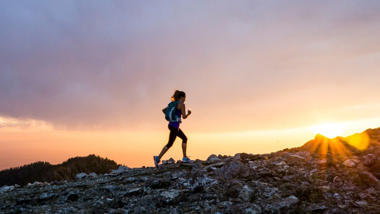 A woman fastpacking in the mountains