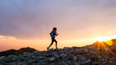 A woman fastpacking in the mountains