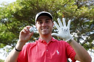 Justin Thomas holds up his ball with 59 on it