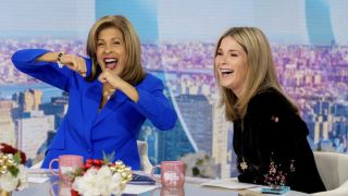 Hoda Kotb dancing in her seat on Today Show while Jenna Bush Hager laughs