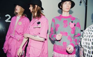 3 Models backstage in the vibrant bubble pink collection by Chitose Abe