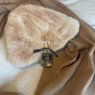 Bottle of Krigler Villa Isar 224 perfume and a fur hat.