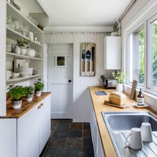 kitchen with white interior and black tile flooring