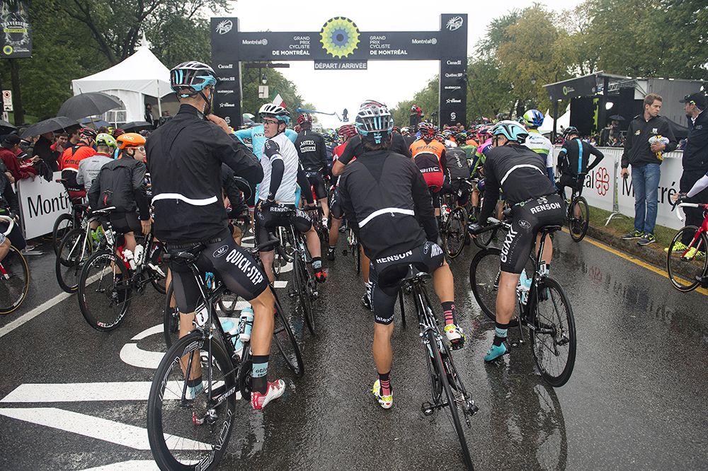 The riders don their rain gear at the start