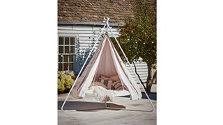 Cox & Cox Hanging Bell Tent in a garden with a white house in the background