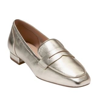 flat lay image of gold loafers