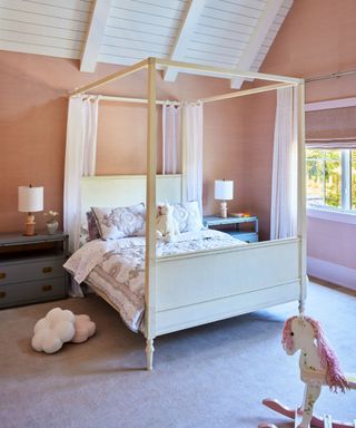 child's room with four-poster and pink walls