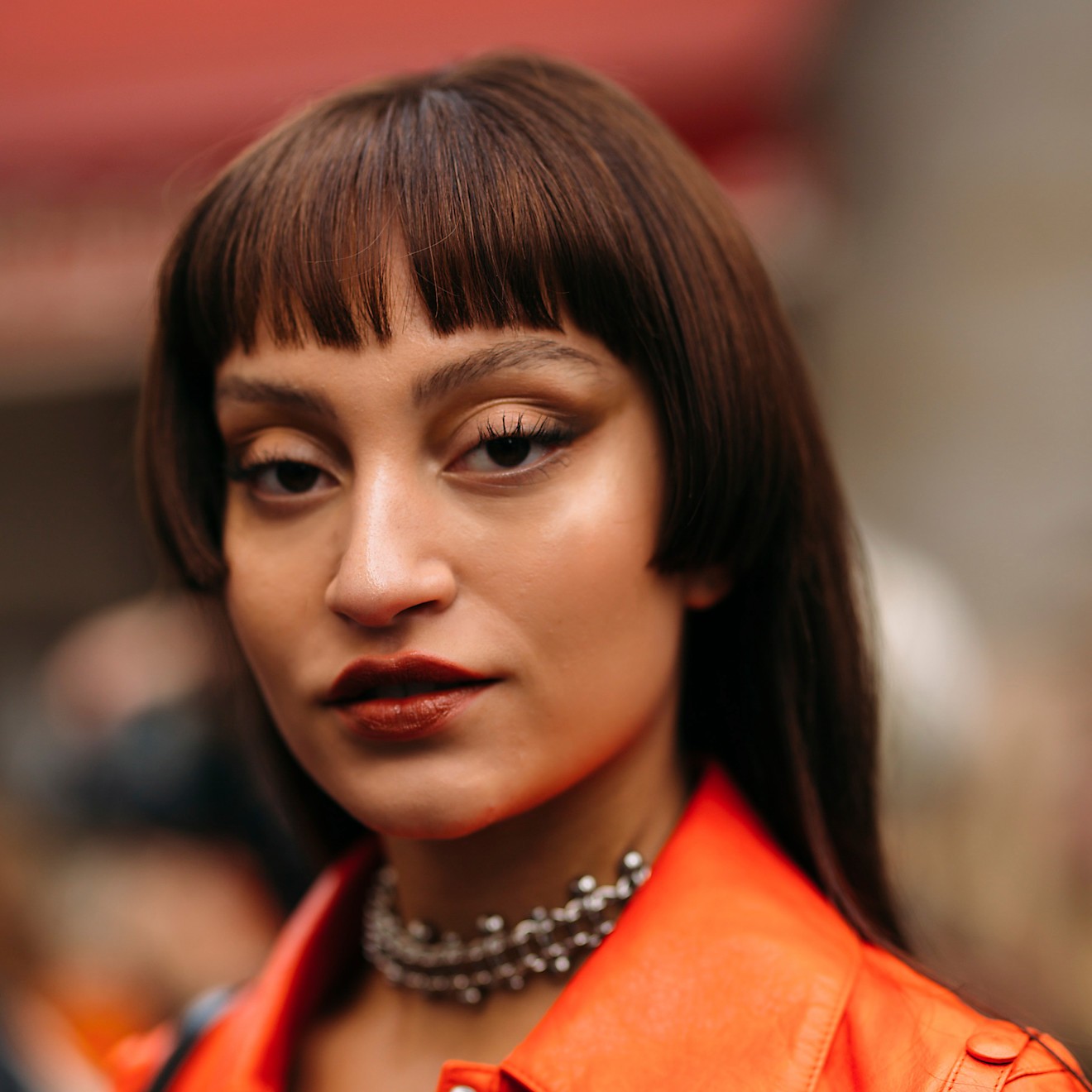 A model wearing their hair styled in a jellyfish cut with micro bangs.
